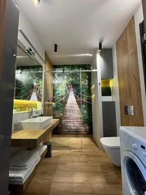 a bathroom with a mural of a suspension bridge at APARTAMENT DĄBSKA 24 TAURON ARENA in Kraków