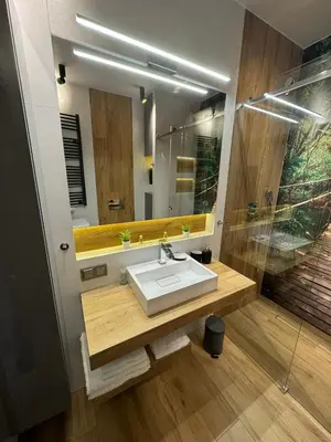 a bathroom with a sink and a mirror at APARTAMENT DĄBSKA 24 TAURON ARENA in Kraków