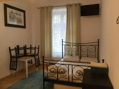 a bedroom with two beds and a window at Main Square Apartaments in Kraków