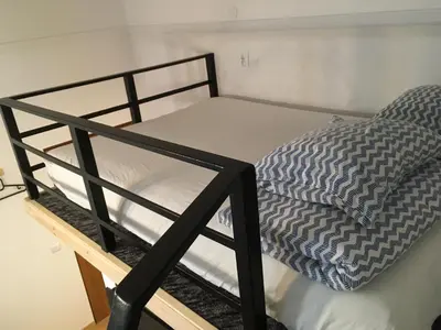 a black bunk bed with a pillow on it at Main Square Apartaments in Kraków