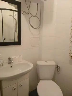 a bathroom with a toilet and a sink and a mirror at Main Square Apartaments in Kraków