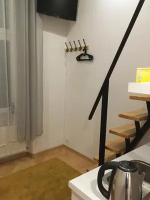 a kitchen with a black arrow on the wall at Main Square Apartaments in Kraków
