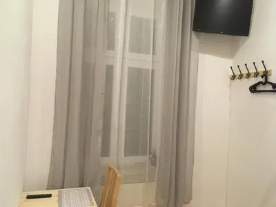 a desk with a computer in front of a window at Pure Apartments in Kraków