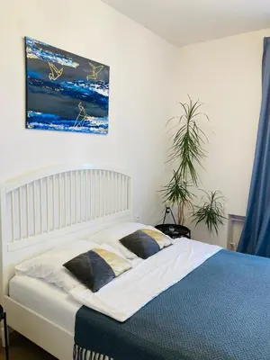 a bedroom with a bed and a painting on the wall at Duo 2 Debniki Modern Apartment near Old Town Fast Wi-Fi Self Check-in in Kraków