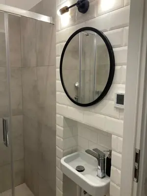 a bathroom with a sink and a mirror at Duo 2 Debniki Modern Apartment near Old Town Fast Wi-Fi Self Check-in in Kraków