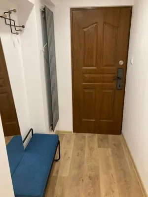 a room with a blue couch and a door at Duo 2 Debniki Modern Apartment near Old Town Fast Wi-Fi Self Check-in in Kraków