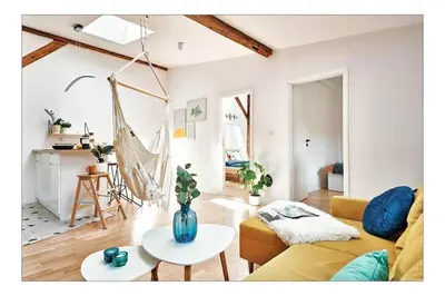 a living room with a couch and a table at Sunny Apartment at the Heart of Old Town in Kraków