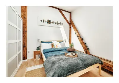 a bedroom with a bed with a blue blanket at Sunny Apartment at the Heart of Old Town in Kraków