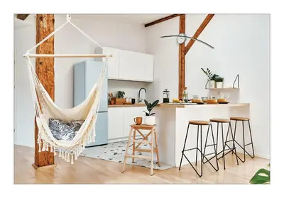 a hanging hammock in a kitchen with a counter at Sunny Apartment at the Heart of Old Town in Kraków