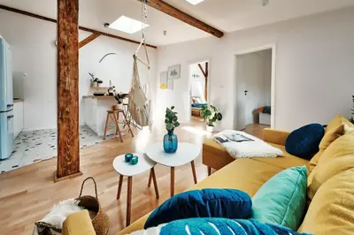a living room with a couch and a table at Sunny Apartment at the Heart of Old Town in Kraków