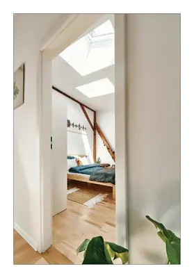 a bedroom with a bed in a attic at Sunny Apartment at the Heart of Old Town in Kraków