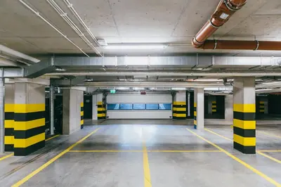 an empty parking garage with yellow and black stripes at Garden Old Town with Free Parking and Garden in Kraków