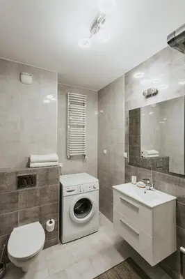 a bathroom with a washing machine and a sink at Garden Old Town with Free Parking and Garden in Kraków