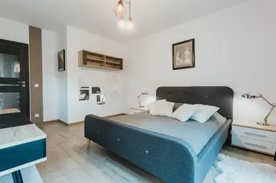 a bedroom with a blue bed in a room at Garden Old Town with Free Parking and Garden in Kraków