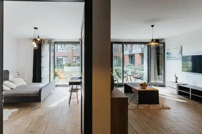 a living room with a couch and a table at Garden Old Town with Free Parking and Garden in Kraków