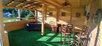 a porch of a cabin with a table and chairs at amel orawa in Podwilk