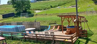 a playground with a wooden deck and a swing at amel orawa in Podwilk