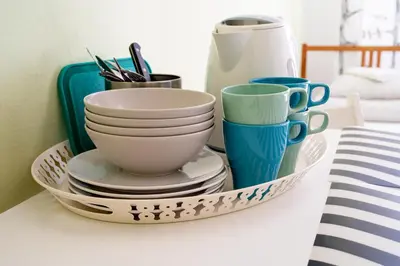 a tray with plates and cups on a table at Trzy Kafki Private Rooms in Kraków
