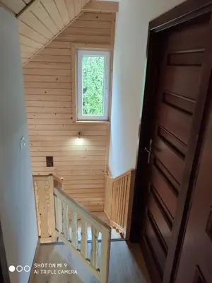 a staircase in a tiny house with a window at Domek u Lucy in Rabka