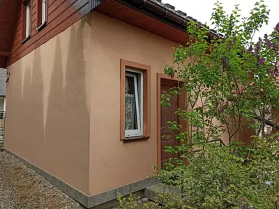 a small house with a window on the side of it at Domek u Lucy in Rabka