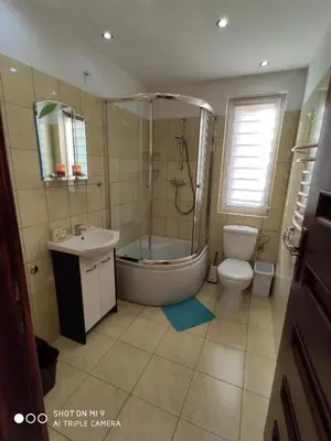 a bathroom with a tub and a toilet and a sink at Domek u Lucy in Rabka