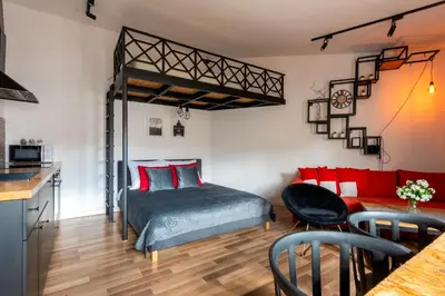 a bedroom with a bed and a red couch at Modern APARTMENT ARIZONA STUDIO OLD TOWN Dietla balcony in Kraków
