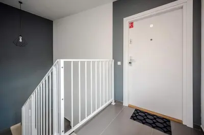 a hallway with a white door and a staircase at Modern APARTMENT ARIZONA STUDIO OLD TOWN Dietla balcony in Kraków