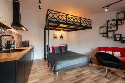 a bedroom with a bed and a kitchen with a sink at Modern APARTMENT ARIZONA STUDIO OLD TOWN Dietla balcony in Kraków