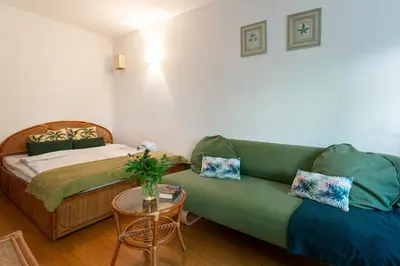 a room with a couch and a bed and a table at Negroni Apartments Stare Miasto in Kraków
