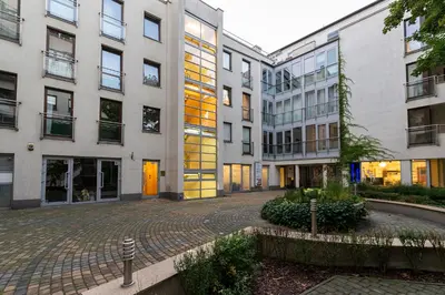an empty courtyard in front of two tall buildings at Negroni Apartments Stare Miasto in Kraków
