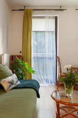 a bedroom with a window and a table and a bed at Negroni Apartments Stare Miasto in Kraków