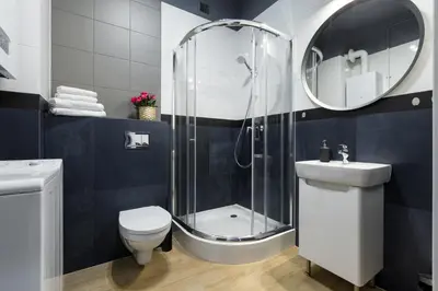 a bathroom with a shower and a toilet and a sink at Friendhouse Residence in Kraków