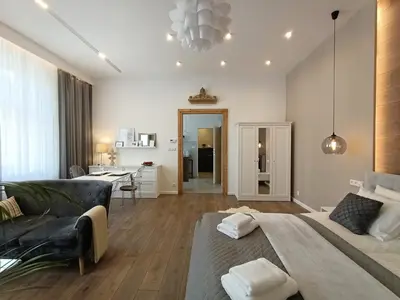 a living room with a large bed and a couch at MyFive Apartments Kraków in Kraków