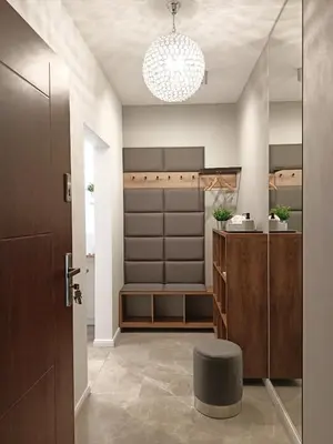 a bathroom with a sink and a stool in a room at MyFive Apartments Kraków in Kraków