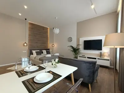a living room with a couch and a table at MyFive Apartments Kraków in Kraków