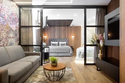 a living room with a couch and a bed at Jacuzzi Apartment Main Square in Kraków