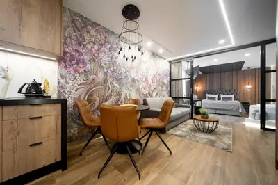 a living room with a large floral mural on the wall at Jacuzzi Apartment Main Square in Kraków