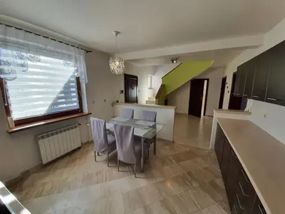 a kitchen and dining room with a table and chairs at Cztery Pory Roku in Rabka