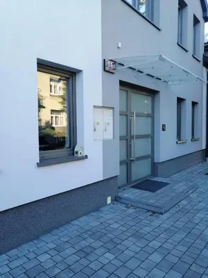 a white building with a door and a window at Prokocim Apartments in Kraków
