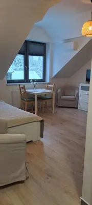 a living room with a table and a couch at Prokocim Apartments in Kraków