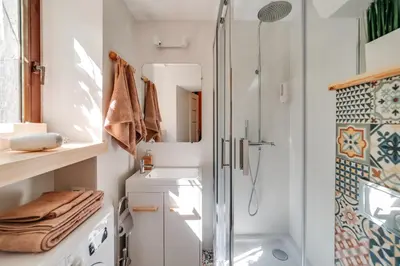 a bathroom with a shower and a sink at ALPARI apartments in Kraków