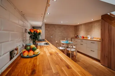a living room with a couch and a table with flowers at ALPARI apartments in Kraków