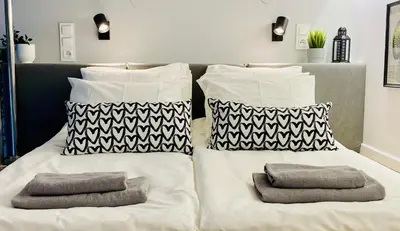 a large white bed with pillows on top of it at Cozy Studio with mezzanine - Old Town, Kazimierz in Kraków