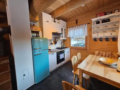 a kitchen with a blue refrigerator and a table at Osada Mała Kozówka in Myślenice