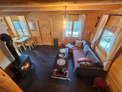a living room with a couch and a wood stove at Osada Mała Kozówka in Myślenice