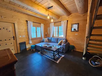 a living room with a couch and a table at Osada Mała Kozówka in Myślenice
