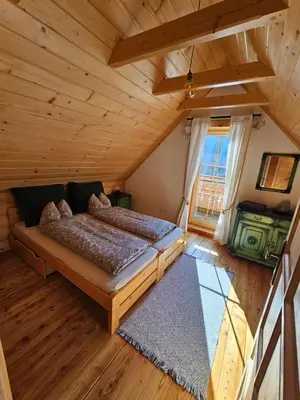 a bedroom with two beds in a log cabin at Osada Mała Kozówka in Myślenice