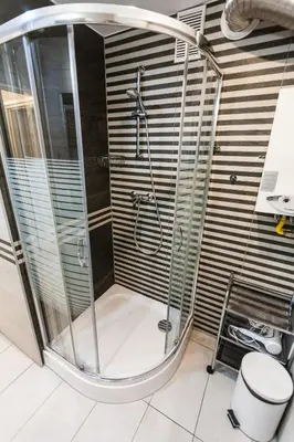 a shower with a glass enclosure in a bathroom at Vintage Tomasza 25 Apartments in Kraków
