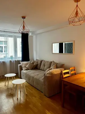 a living room with a couch and two tables at Vintage Tomasza 25 Apartments in Kraków