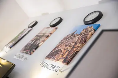 two clocks and a picture of a building at Green - Apartamenty Kleparskie in Kraków